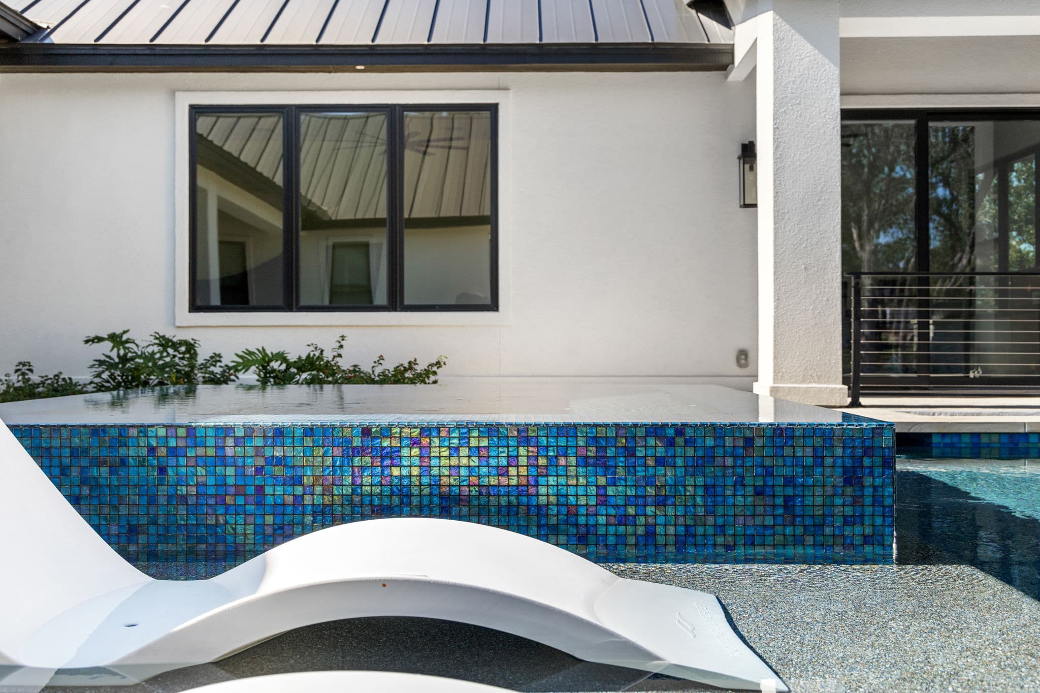 Modern infinity-edge pool overlooking Hill Country sunset