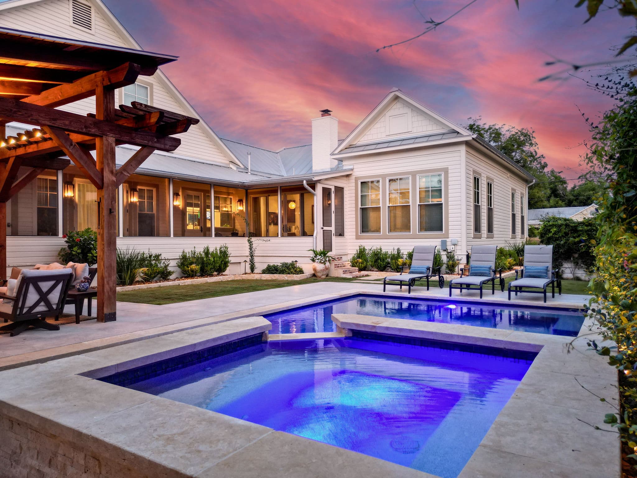 Custom gunite pool with raised spa and stone coping